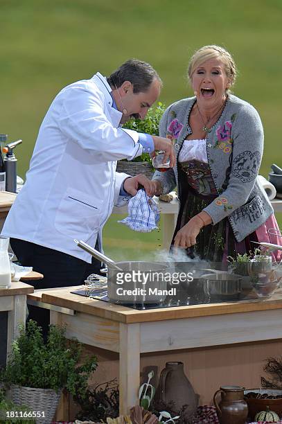 Johann Lafer and Andrea Kiewel during the recording of the TV Show 'ZDF Fernsehgarten' at Seiser Alm near Kastelruth on September 18, 2013 in...