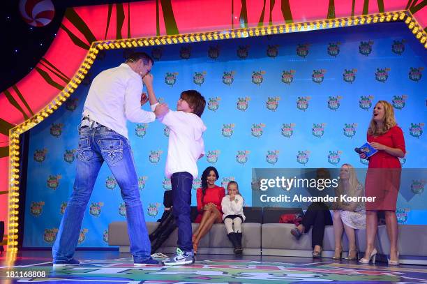 Former German Boxer Henry Maske performs together with the ten year-old Leon a boxing performance during a Ferrero kinderTag 2013 event at Heidepark...