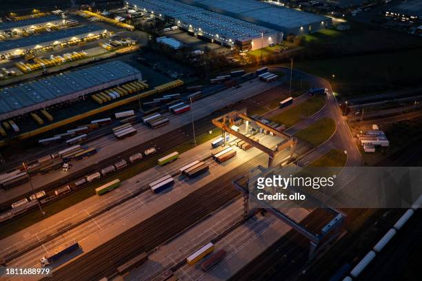 large industrial and business park - aerial view at dusk - train yard at night stock pictures, royalty-free photos & images