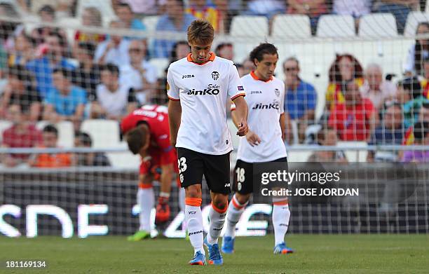 Valencia's midfielder Sergio Canales reacts after Swansea scored during the UEFA Europa league football match Valencia CF vs Swansea City AFC at the...