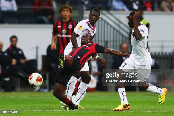 Constant Djakpa of Frankfurt is challenged by Andre Biyogo Poko and Abdou Traore of Bordeaux during the UEFA Europa League Group F match between...