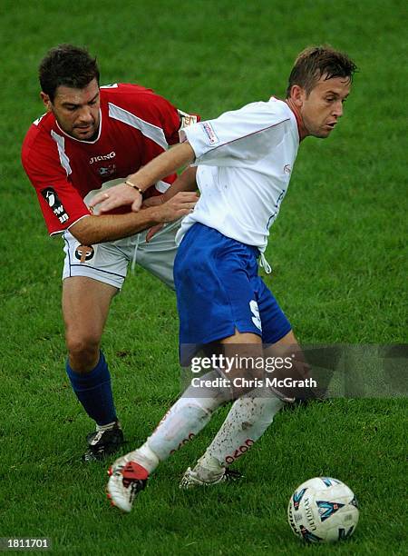 Leon Buhic of the Knights is challenged by Ante Deur of United during the round 23 NSL match between Sydney United and the Melbourne Knights held at...