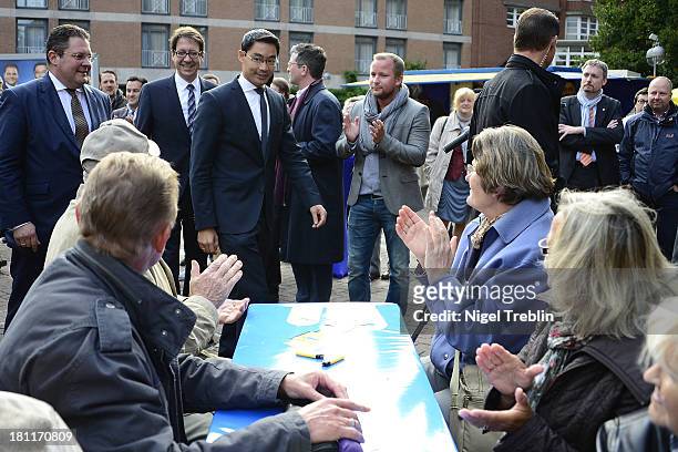 German Free Democrats party chairman Philipp Roesler and secretary general Patrick Doering arrives to a party's election campaign on September 19,...