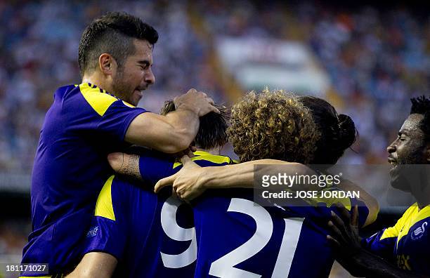 Swansea City's players celebrate their second score during the UEFA Europa league football match Valencia CF vs Swansea City AFC at the Mestalla...