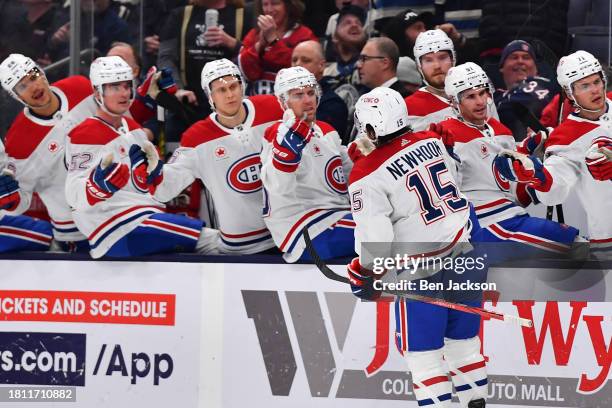 Alex Newhook of the Montreal Canadiens high-fives his teammates after scoring a goal during the second period of a game against the Columbus Blue...