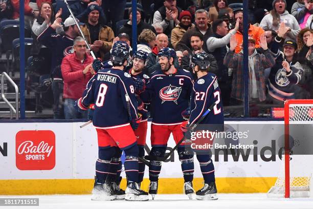 Yegor Chinakhov of the Columbus Blue Jackets celebrates his second period goal with his teammates during a game against the Montreal Canadiens at...