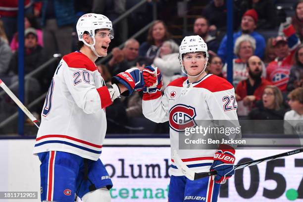 Cole Caufield of the Montreal Canadiens celebrates his second period goal with teammate Juraj Slafkovsky of the Montreal Canadiens during a game...