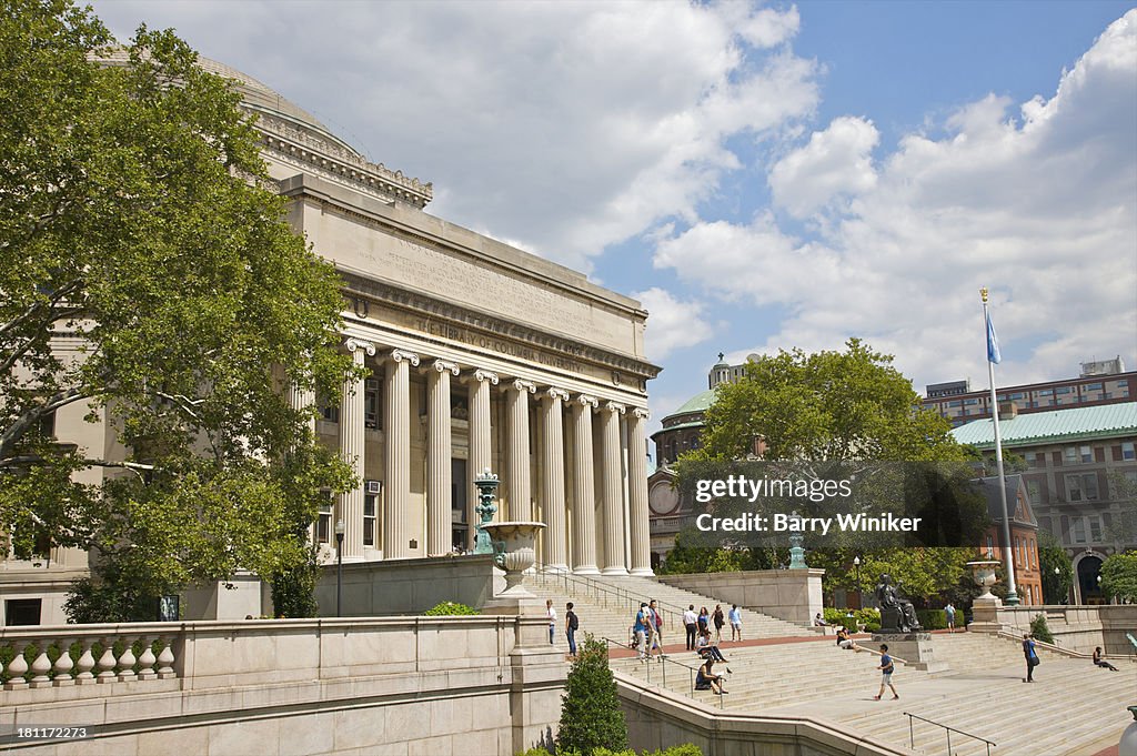 People on steps leading to columned building