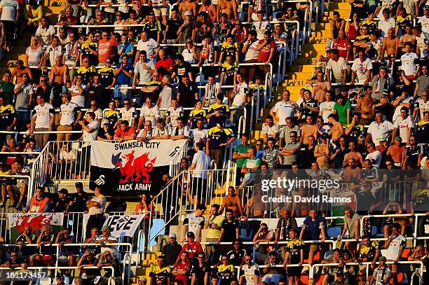 Swansea City supporters cheer their team during the UEFA Europa League Group A match between Valencia CF and Swansea City at Estadi de Mestalla on...