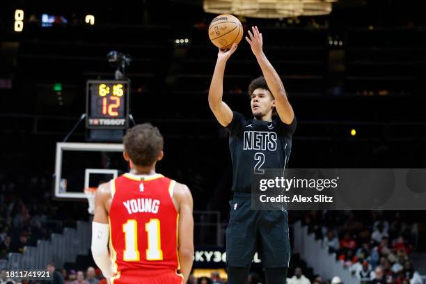 Cameron Johnson of the Brooklyn Nets shoots over Trae Young of the Atlanta Hawks during the second half at State Farm Arena on November 22, 2023 in...