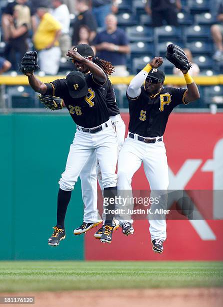Andrew McCutchen, Felix Pie and Josh Harrison of the Pittsburgh Pirates celebrate after defeating the San Diego Padres on September 19, 2013 at PNC...