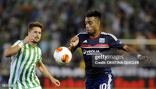 Lyon's French forward Alexandre Lacazette vies with Betis' German defender Markus Steinhofer during the UEFA Europa League football match Real Betis...