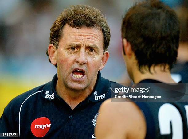 Dennis Pagan, coach of Carlton, addresses his players at quarter time during the Wizard Home Loans Cup pre-season game between the Collingwood...