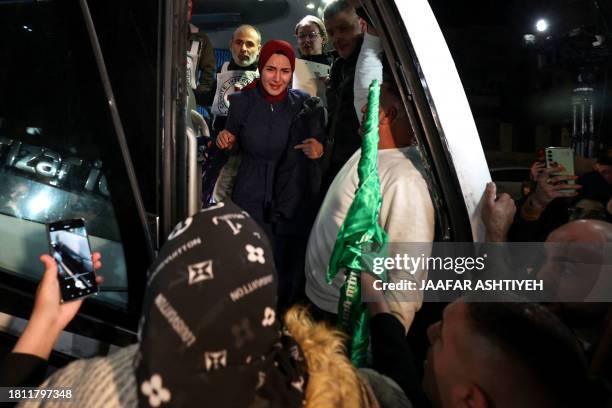 Newly released prisoner disembarks a bus during a welcome ceremony following the release of Palestinian prisoners from Israeli jails in exchange for...