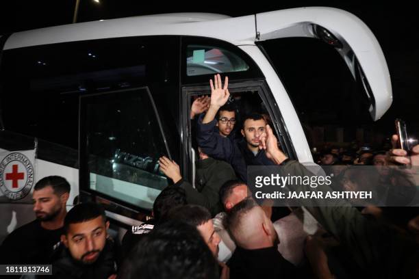 Newly released prisoners disembark a bus during a welcome ceremony following the release of Palestinian prisoners from Israeli jails in exchange for...