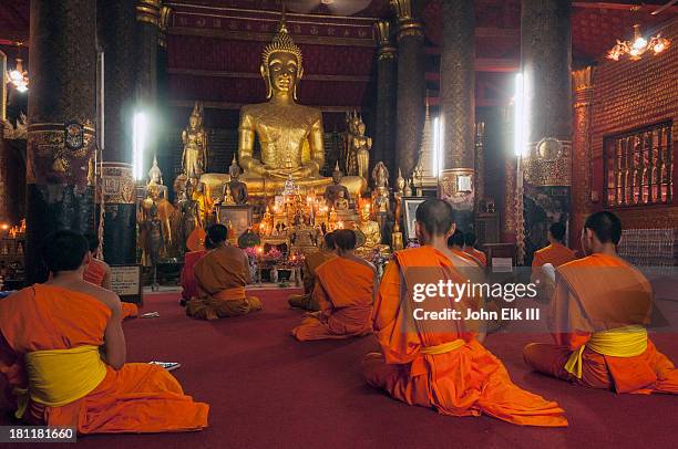 wat mai, interior buddha figure with monks - monks stock pictures, royalty-free photos & images