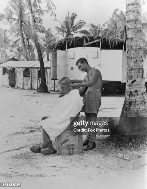An RAF serviceman having his hair cut on Christmas Island in the Central Pacific Ocean, during preparations for the Operation Grapple British nuclear...