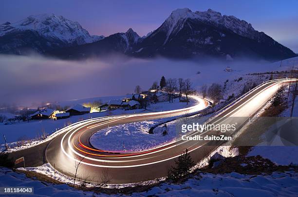 light trails on german mountain road in winter - frozen and blurred motion stock pictures, royalty-free photos & images