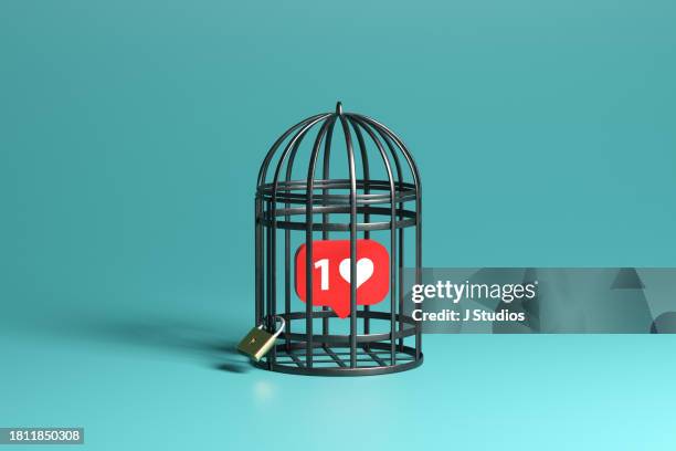 social media icon locked in birdcage - loneliness icon stock pictures, royalty-free photos & images