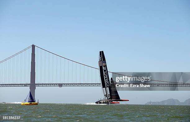 Oracle Team USA skippered by James Spithill warms up near the Golden Gate Bridge before race 12 against Emirates Team New Zealand in the America's...