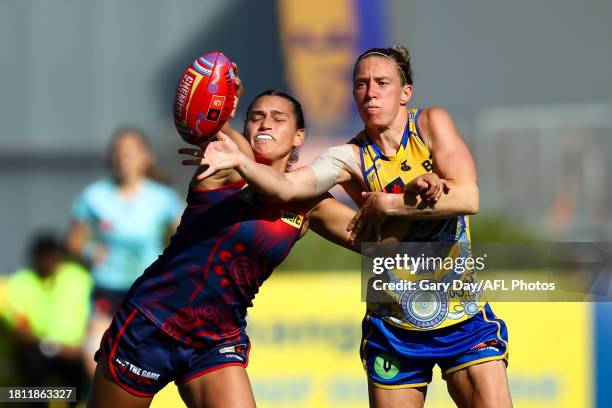 Emma Swanson of the Eagles and Eliza West of the Demons compete for the ball during the 2023 AFLW Round 07 match between the West Coast Eagles and...