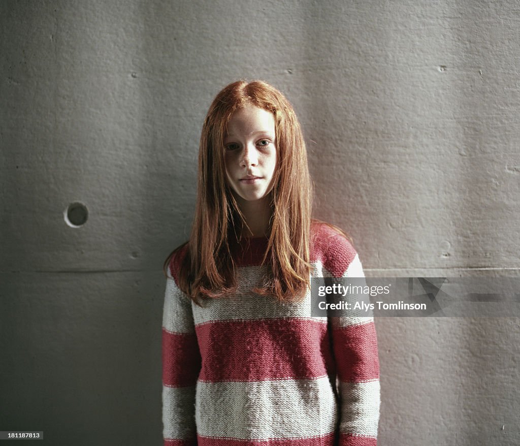 Girl standing in front of a wall