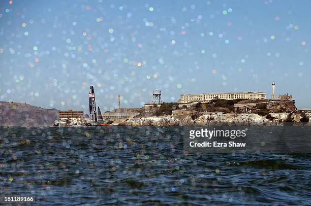 Oracle Team USA skippered by James Spithill sails past Alcatraz Island during race 12 against Emirates Team New Zealand in the America's Cup Finals...