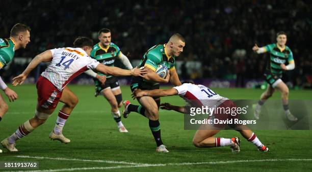Ollie Sleightholme of Northampton Saints goes past Marcus Smith and Cadan Murley to score their first try during the Gallagher Premiership Rugby...