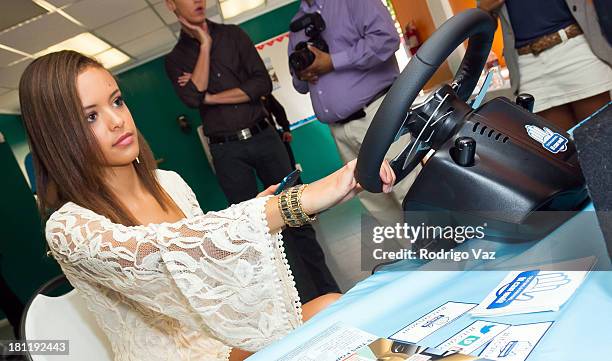 American Idol participant and singer Aubrey Cleland demonstrates AT&T Texting & Driving Simulator on September 19, 2013 in Los Angeles, California.