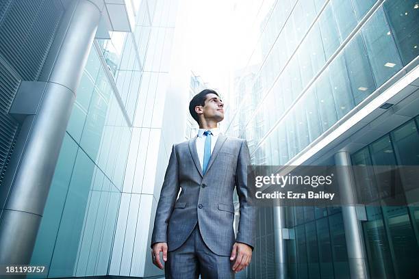 businessman looking up at city skyline - low angle view stock pictures, royalty-free photos & images