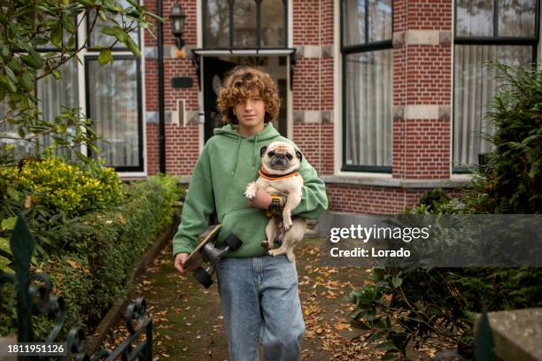 portrait of a teenage boy with a dog in holland - nederlandse cultuur stockfoto's en -beelden