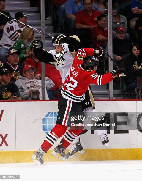 Brandon Bollig of the Chicago Blackhawks collides with Deryk Engelland of the Pittsburgh Penguins during an exhibition game at United Center on...