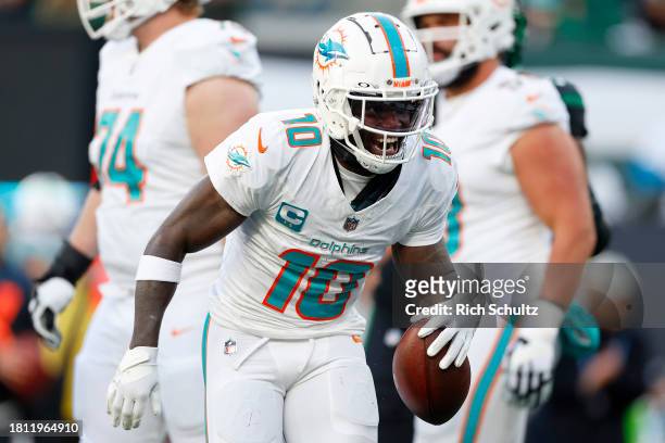 Tyreek Hill of the Miami Dolphins celebrates a first down catch against the New York Jets during the first quarter in the game at MetLife Stadium on...