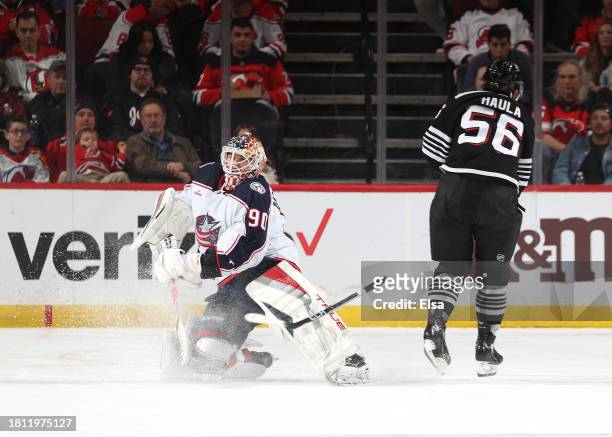 Elvis Merzlikins of the Columbus Blue Jackets clears a shot by Erik Haula of the New Jersey Devils during the first period at Prudential Center on...