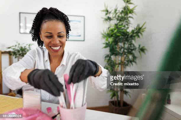 smiling professional manicurist at home office - nail salon stock pictures, royalty-free photos & images