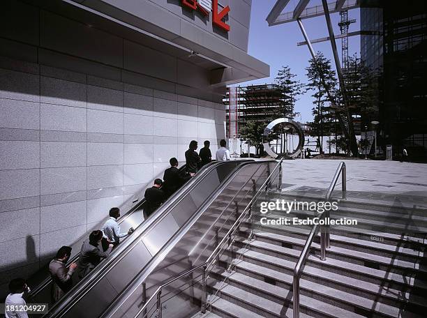 office employees using an outdoor moving elevator - packed elevator stock pictures, royalty-free photos & images