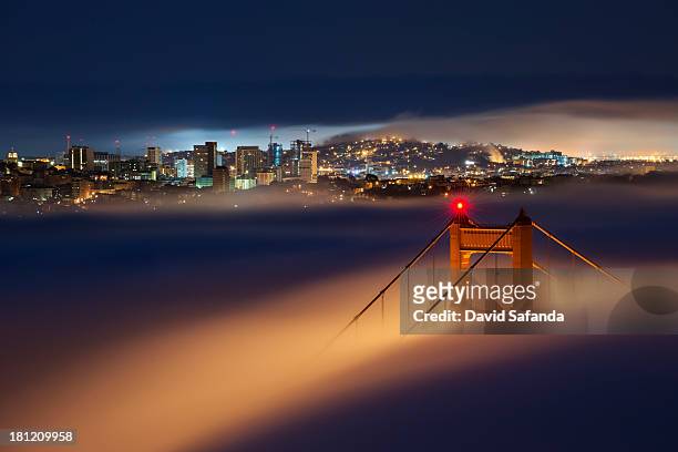 golden gate at night - golden gate bridge city fog stock pictures, royalty-free photos & images