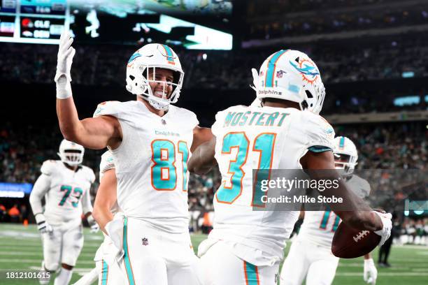 Raheem Mostert of the Miami Dolphins celebrates with Durham Smythe after scoring a touchdown against the New York Jets during the fourth quarter in...
