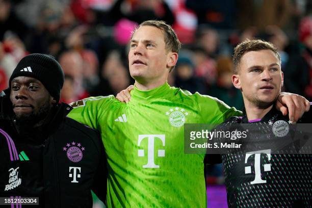 Alphonso Davies, Manuel Neuer and Joshua Kimmich of Bayern Munich interact following the Bundesliga match between 1. FC Köln and FC Bayern München at...