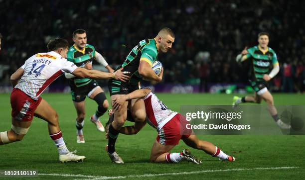 Ollie Sleightholme of Northampton Saints goes past Marcus Smith and Cadan Murley to score their first try during the Gallagher Premiership Rugby...