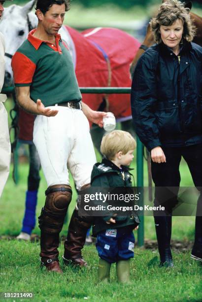Charles, Prince of Wales, Prince Harry and his nanny Ruth Wallis during a polo match at Cirencester Polo Club on June 6, 1987 in Cirencester, England.
