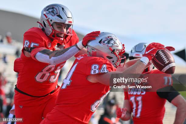 Tight end Trace Bruckler and tight end Wyatt McClour of the New Mexico Lobos celebrate after McClour scored a touchdown against the Utah State Aggies...