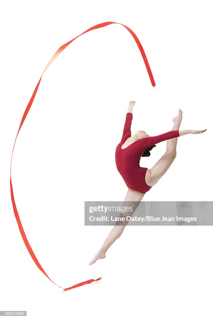 Female gymnast performing rhythmic gymnastics with ribbon