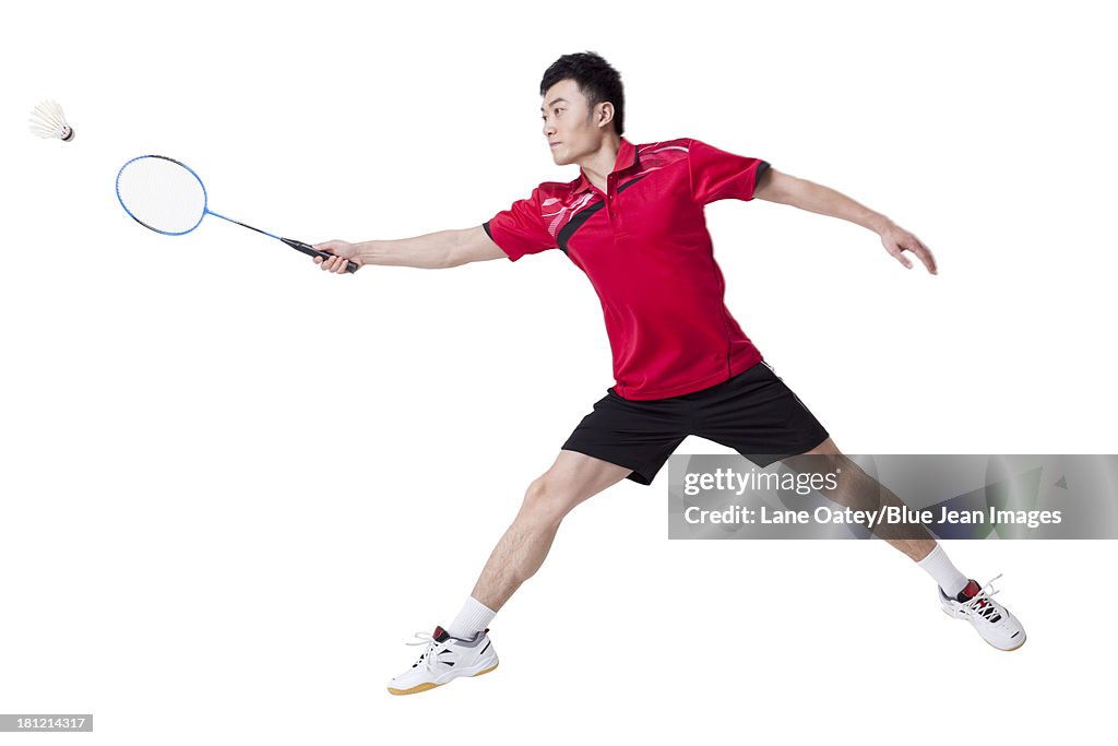 Male athlete playing badminton