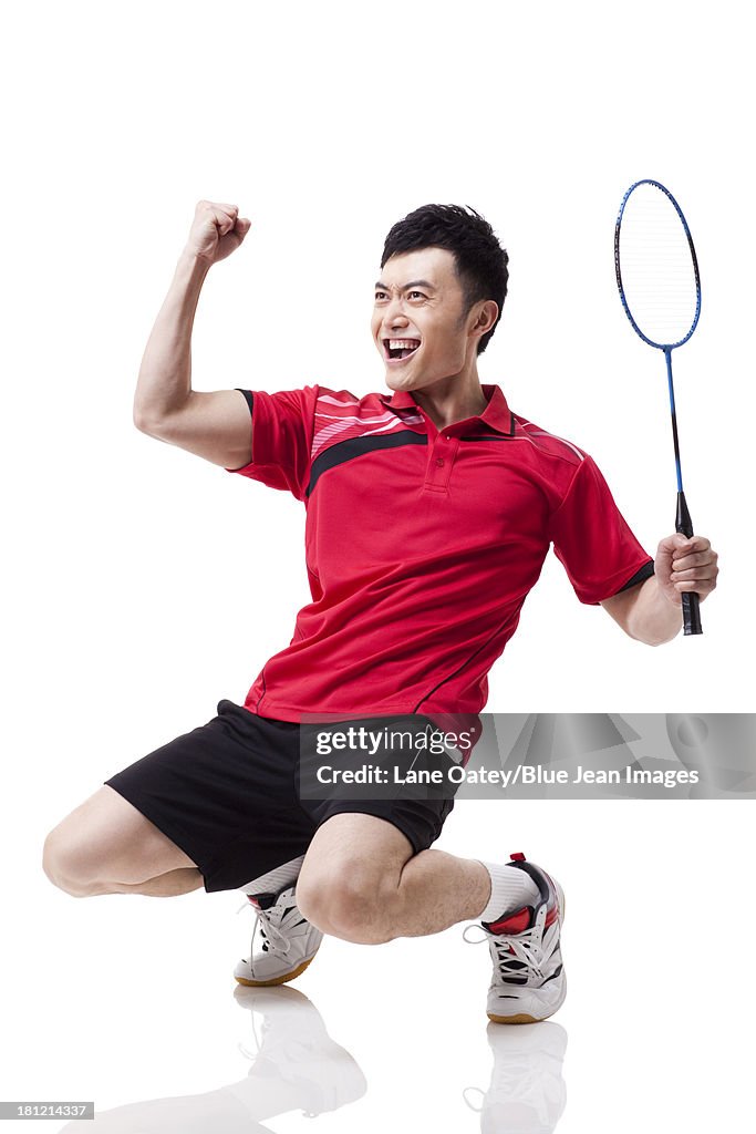 Male badminton player celebrating with excitement