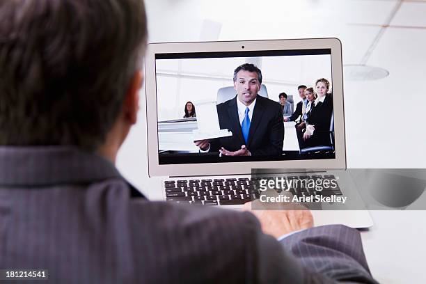 businessmen having teleconference meeting - boss over shoulder stock-fotos und bilder