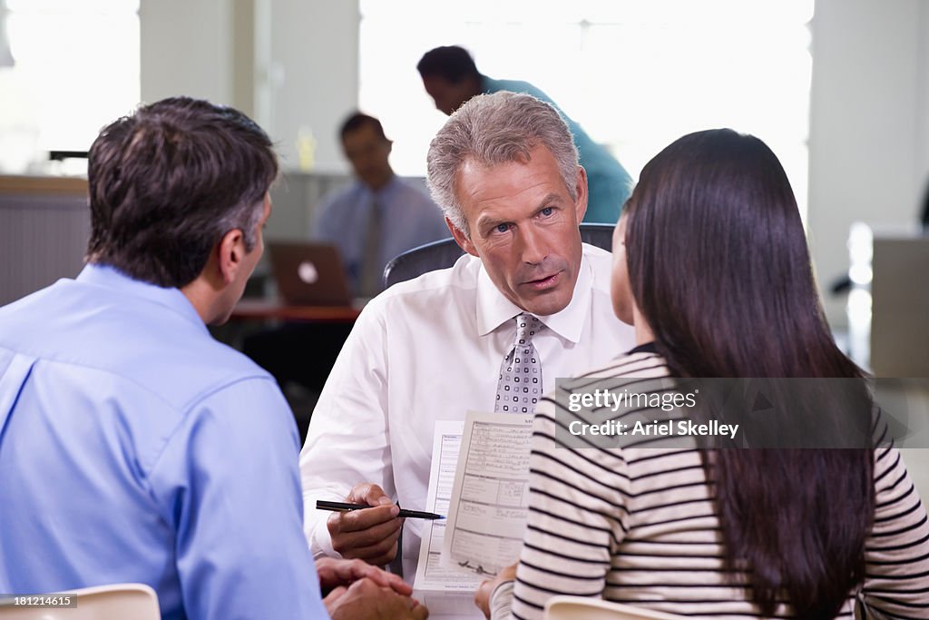 Businessman and clients talking at desk