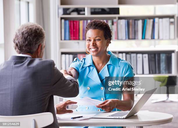 business people shaking hands at desk - african american interview foto e immagini stock