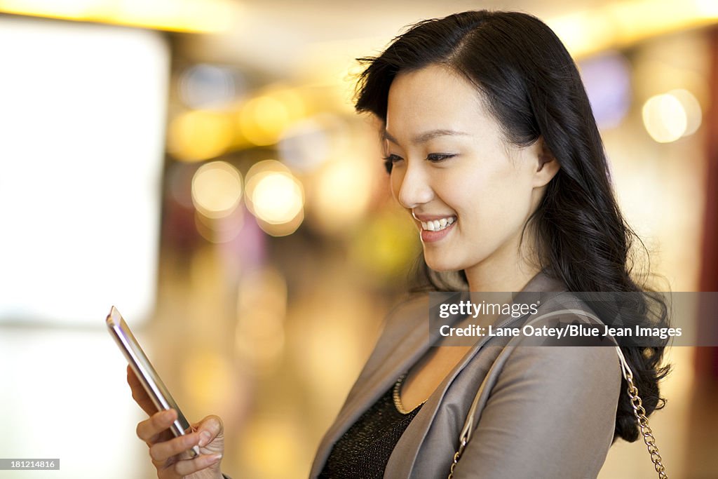 Cheerful young woman with smart phone