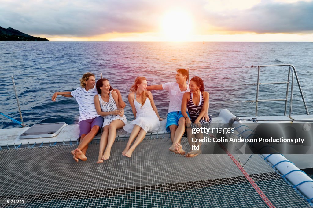 Friends relaxing on boat in ocean